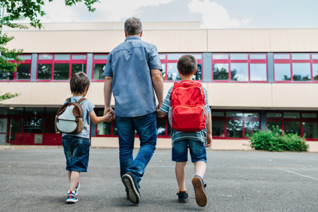 father dropping off children at school