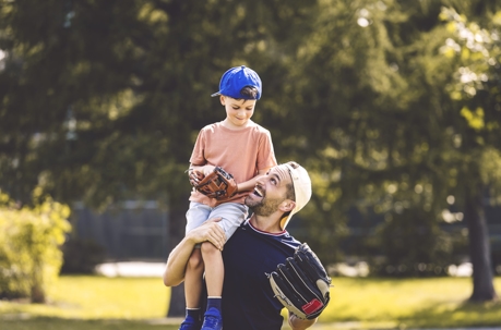 father and son playing in the park