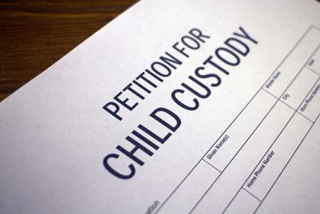 Someone filling out petition for child custody