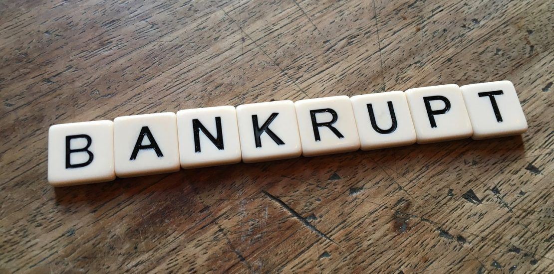 bankruptcy spelled out with lettered tiles