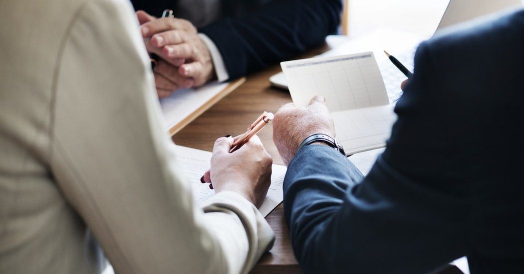 business men signing paperwork