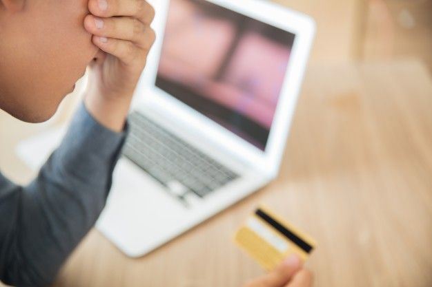 businessman looking at credit card in stress