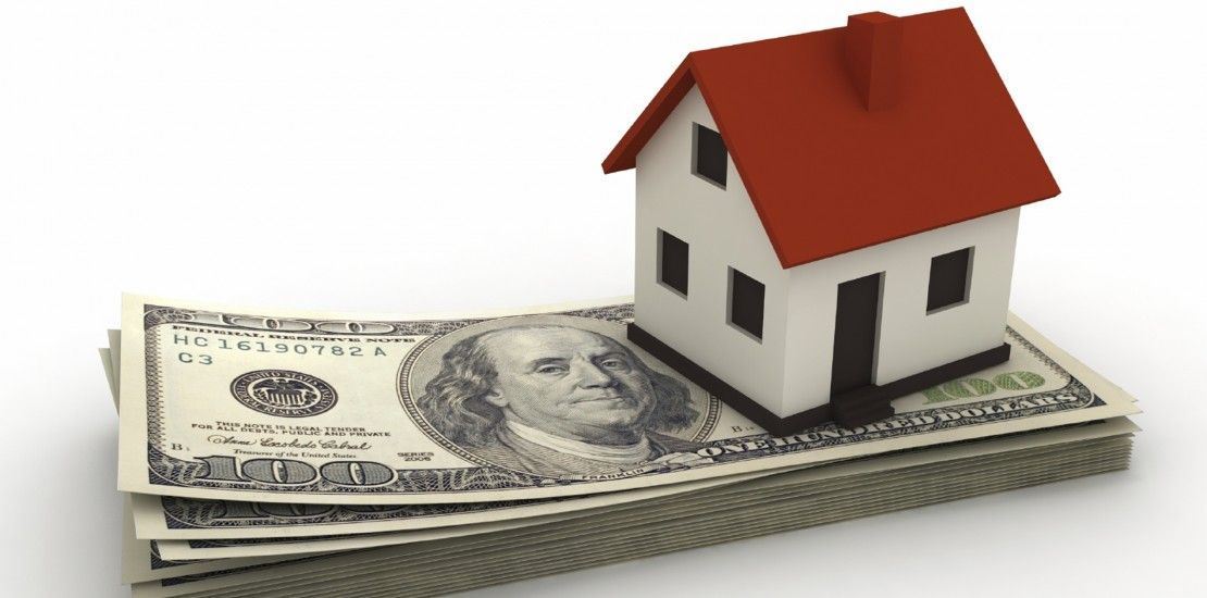 house sitting on $100 bills